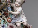 a figurine of a child sitting on a clock