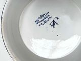 a white bowl with a blue design on it