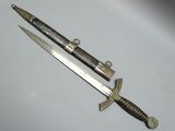 a knife that is laying next to a knife on a table