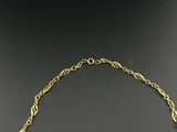 a gold necklace with an oval link and a chain around it