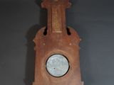 an old wooden clock hanging on the wall in a room