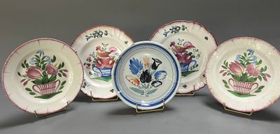 six plates with flowers and birds painted on them on a gray surface