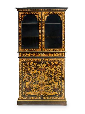 a black and gold painted cabinet with glass doors