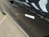 a sticker on the door of a car that has been vandalized