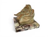 statue of a woman sitting on a chair on a marble base