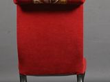 pair of red upholstered chairs with a gold and red upholstered cushion