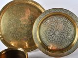 a gold plate and a silver plate on a white background