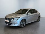a silver car is parked in a room with a white wall