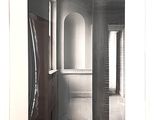 a black and white photo of a hallway in a house