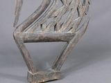 a sculpture of a bird that is sitting on top of a chair
