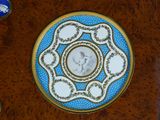a blue and white plate with a picture of a man on it
