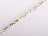 a close up of a gold chain bracelet on a white background