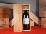 a bottle of red wine in a wooden box