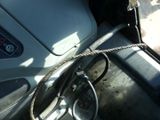 a steering wheel and a rope on the dashboard of a car