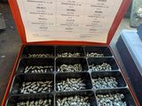 a box of nuts and screws sitting on the floor