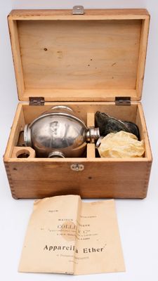 a wooden box with a silver plate inside of it
