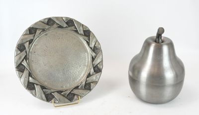 une assiette en argent et une poire en argent, l'une à côté de l'autre