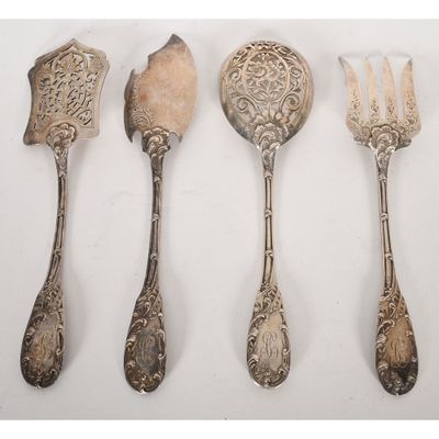 five silver spoons and a fork on a white surface