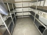 a room with a lot of shelvings and shelves in it