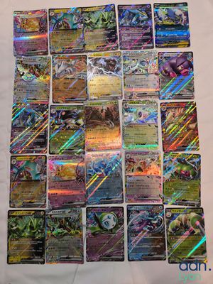 a pile of pokemon cards sitting on top of a table