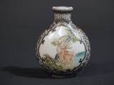 a small vase with a picture of a deer on it