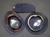 two hats that are sitting next to each other on a table