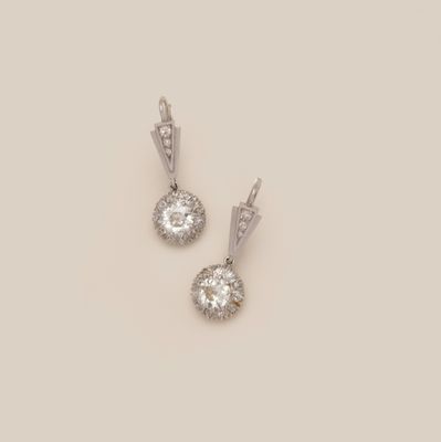 a pair of diamond and white gold earrings