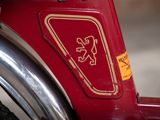 a close up of a red bike with a sticker on it