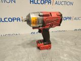 an electric drill is sitting on a table in front of a wall