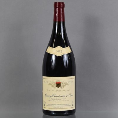 a bottle of wine sitting on top of a glass table