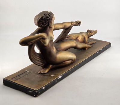 bronze sculpture of a woman and a cat on a wooden base