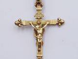 a gold crucif cross with a person on the cross