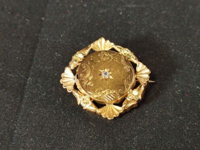 an image of a gold ring with a coin in the center