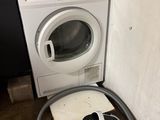 une photo montrant une machine à laver et un sèche-linge dans une pièce