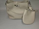 Ensemble sac à main et porte-monnaie en cuir beige sur fond blanc