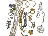 many different types of necklaces and bracelets on a white surface