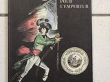 livre en français accroché au mur de toilettes publiques, avec la photo d'un homme tenant un drapeau