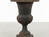 a large black vase sitting on top of a white floor