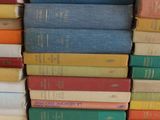many books stacked on top of each other on a table