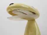 a close up of a yellow object on a white surface