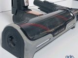 someone is using a cordless vacuum cleaner to clean the floor