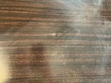 a blurry image of a person ' s face on a wooden table
