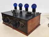 a wooden box with four blue lights on it