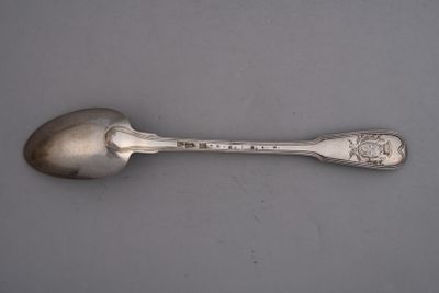 silver spoon on a table with a silver handle and a silver spoon with a silver handle