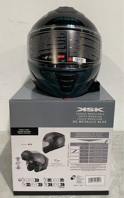 a black helmet on top of a box on the floor