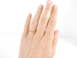 a woman ' s hand with a gold ring on it