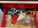 a red tool box with tools in it on the floor