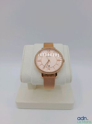 a close up of a watch on a display stand on a white surface