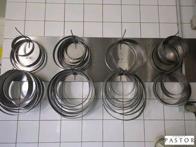 a lot of pots and pans that are hanging on the wall