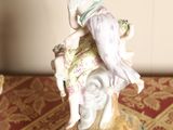 a figurine of a woman riding a horse on a table